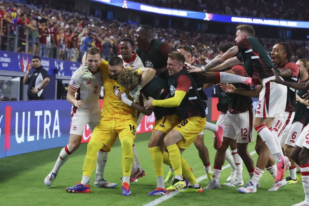 Canada celebrates their win over Venezuela in a Copa America quarterfinal soccer match in Arlington, Texas, Friday, July 5, 2024. (AP Photo/Richard Rodriguez)
