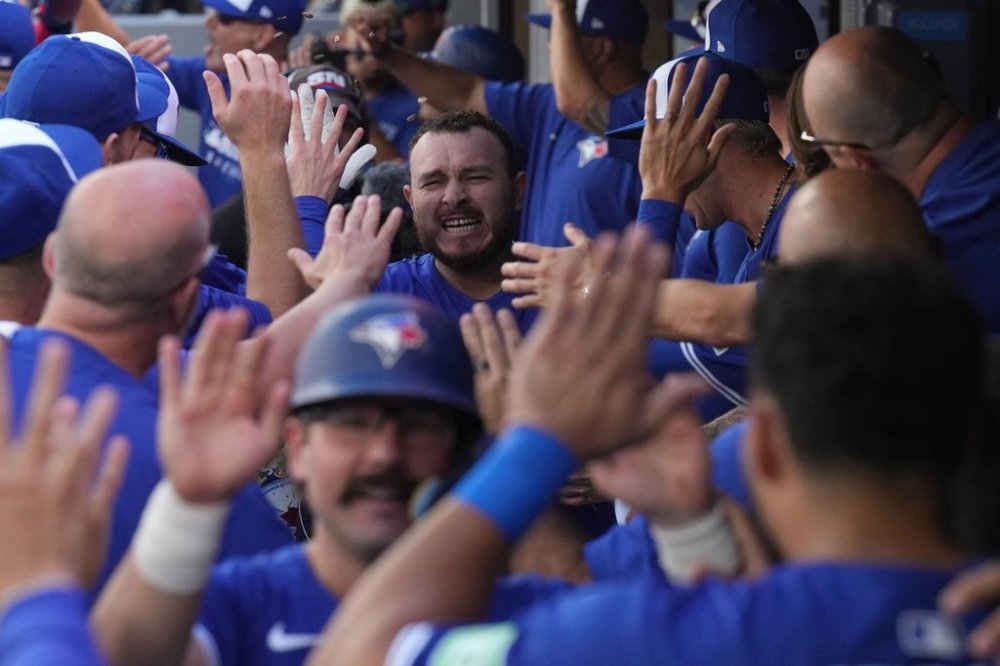 Blue Jays catcher Alejandro Kirk, top centre, celebrates with teammates in the dugout after hitting a grand slam against the Tampa Bay Rays during the first inning of a Major League Baseball game in Toronto on Sept. 28, 2025. THE CANADIAN PRESS/Chris Young