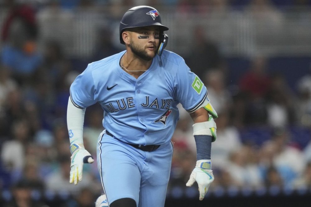 Toronto Blue Jays' Bo Bichette runs after a single during a baseball game against the Miami Marlins, Sunday, Aug. 24, 2025, in Miami. (AP Photo/Marta Lavandier)