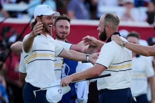 Europe's Tyrrell Hatton celebrates with Tommy Fleetwood on the 18th hole during their singles match on the Bethpage Black golf course at the Ryder Cup golf tournament, Sunday, Sept. 28, 2025, in Farmingdale, N.Y. (AP Photo/Matt Slocum)