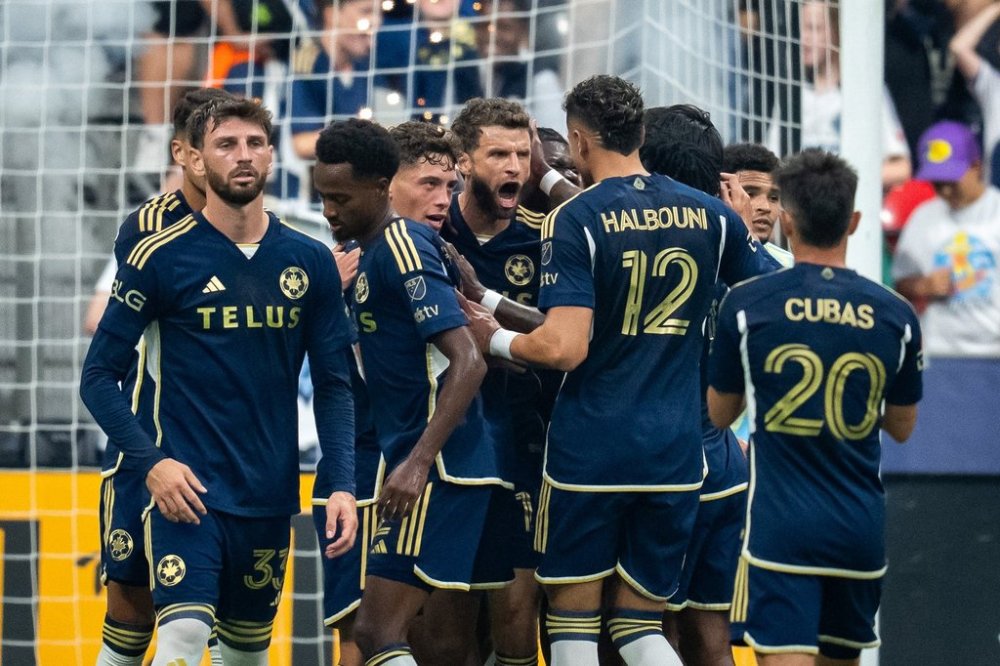 Vancouver Whitecaps' Thomas Muller (13) celebrates his goal against the Philadelphia Union with teammates during the first half of an MLS soccer match in Vancouver, on Saturday, Sept. 13, 2025. THE CANADIAN PRESS/Ethan Cairns