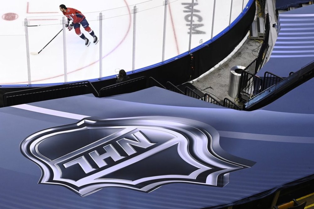 An NHL logo is shown as Washington Capitals defenceman Brenden Dillon (4) skates prior to NHL Eastern Conference Stanley Cup playoff hockey action against the New York Islanders in Toronto on Friday, Aug. 14, 2020. A group of Facebook pages has been pumping out fake stories about NHL players and teams. THE CANADIAN PRESS/Nathan Denette
