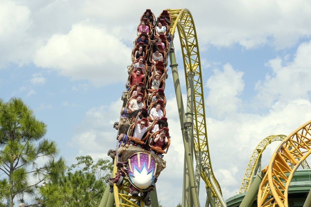 FILE - Guests ride on the Stardust Racers roller coaster at Epic Universe Theme Park at Universal Resort Orlando, April 10, 2025, in Orlando, Fla. (AP Photo/John Raoux, file)