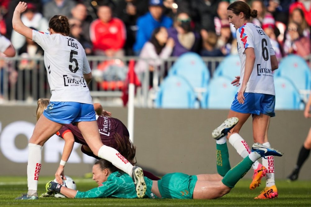 AFC Toronto forward Kaylee Hunter (11) collides with Montreal Roses FC goalkeeper Anna Karpenko (1) during second half Northern Super League soccer action in Toronto on Saturday, April 19, 2025. THE CANADIAN PRESS/Arlyn McAdorey