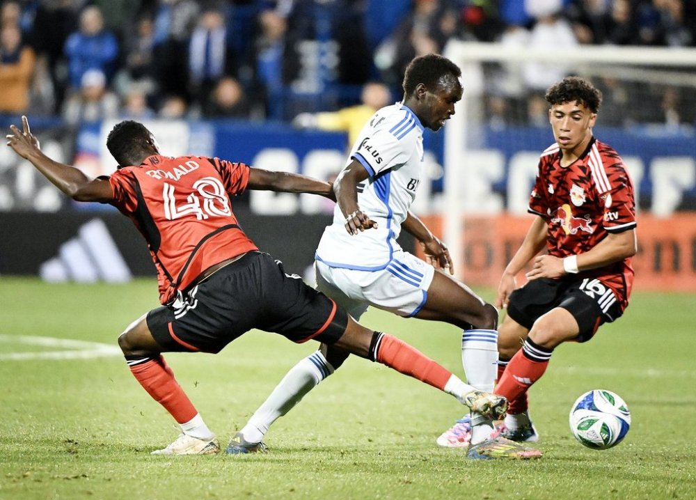 New York Red Bulls' Ronald Donkor (48) and Julian Hall (16) defend against CF Montreal's Victor Loturi (22) during first half MLS soccer action in Montreal, Saturday, Sept. 20, 2025. THE CANADIAN PRESS/Graham Hughes