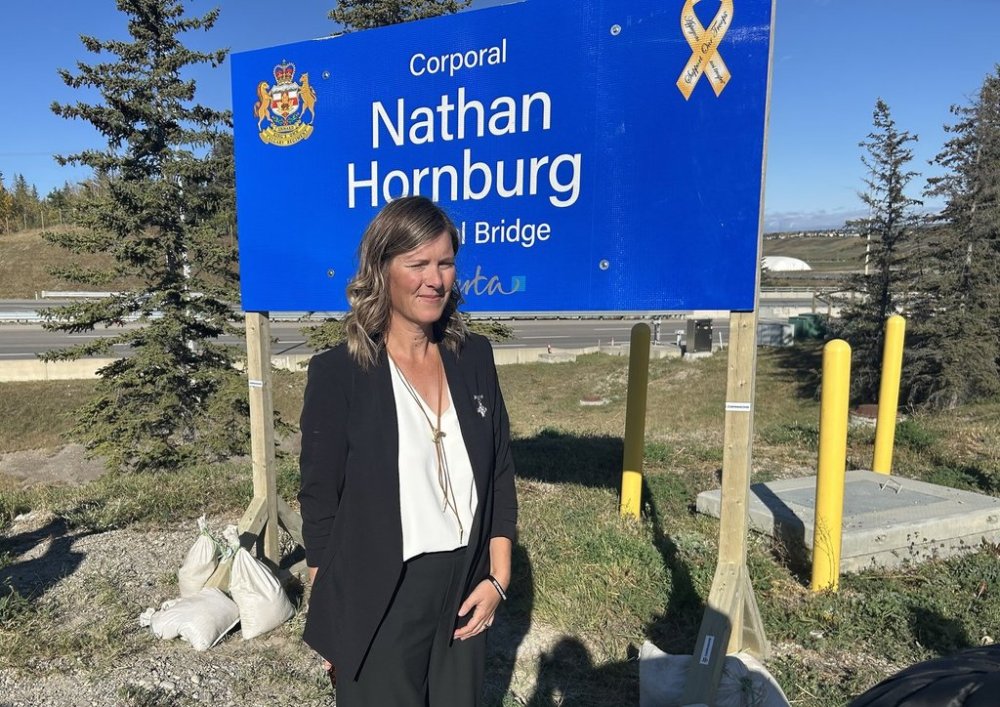 Rachel Herbert stands before a Calgary bridge being named in honour of her brother, Cpl. Nathan Hornburg on Wednesday, Sept. 24, 2025. The reservist from Calgary was killed in 2007 while working to recover a disabled tank under fire by the Taliban in Afghanistan. THE CANADIAN PRESS/Bill Graveland
