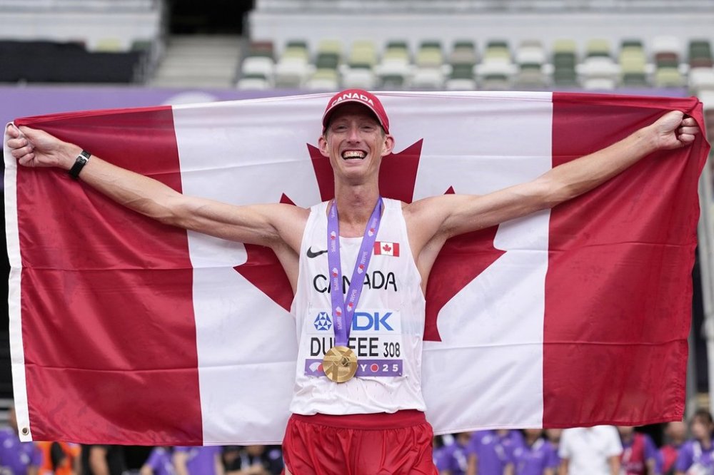 Canada's Evan Dunfee poses after winning gold in the men's 35-kilometres race walk at the world athletics championships in Tokyo on Saturday, Sept. 13, 2025. (AP Photo/Matthias Schrader)