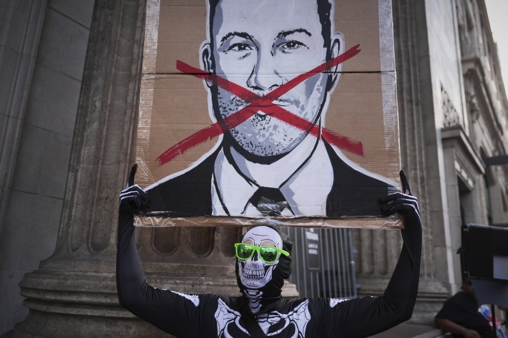 Asher Rogers holds an image of Jimmy Kimmel outside El Capitan Entertainment Centre, where the late-night show