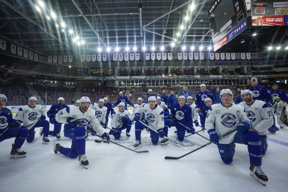 Vancouver Canucks players, including Marcus Pettersson (29), Aatu Raty (54), Brock Boeser (6) and Derek Forbort (27) listen to instructions for a drill during the opening day of the NHL hockey team's training camp, in Penticton, B.C., on Thursday, September 18, 2025. THE CANADIAN PRESS/Darryl Dyck