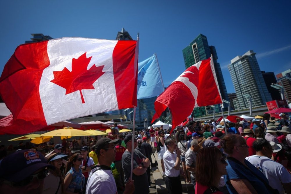 Flags flap in the wind during Canada Day festivities in Vancouver on Tuesday, July 1, 2025. THE CANADIAN PRESS/Darryl Dyck