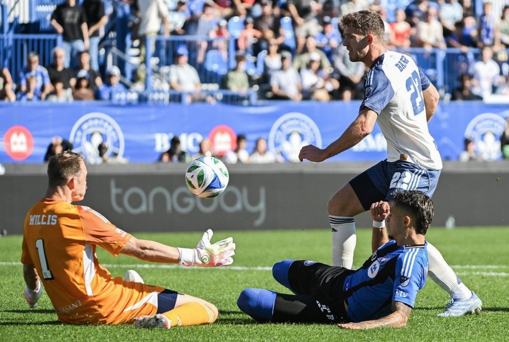 Nashville SC's goalkeeper Joe Willis (1) makes a save against CF Montreal's Ivan Jaime (11) as Nashville's Josh Bauer (22) defends during first half MLS soccer action in Montreal, Saturday, Oct. 4, 2025. THE CANADIAN PRESS/Graham Hughes