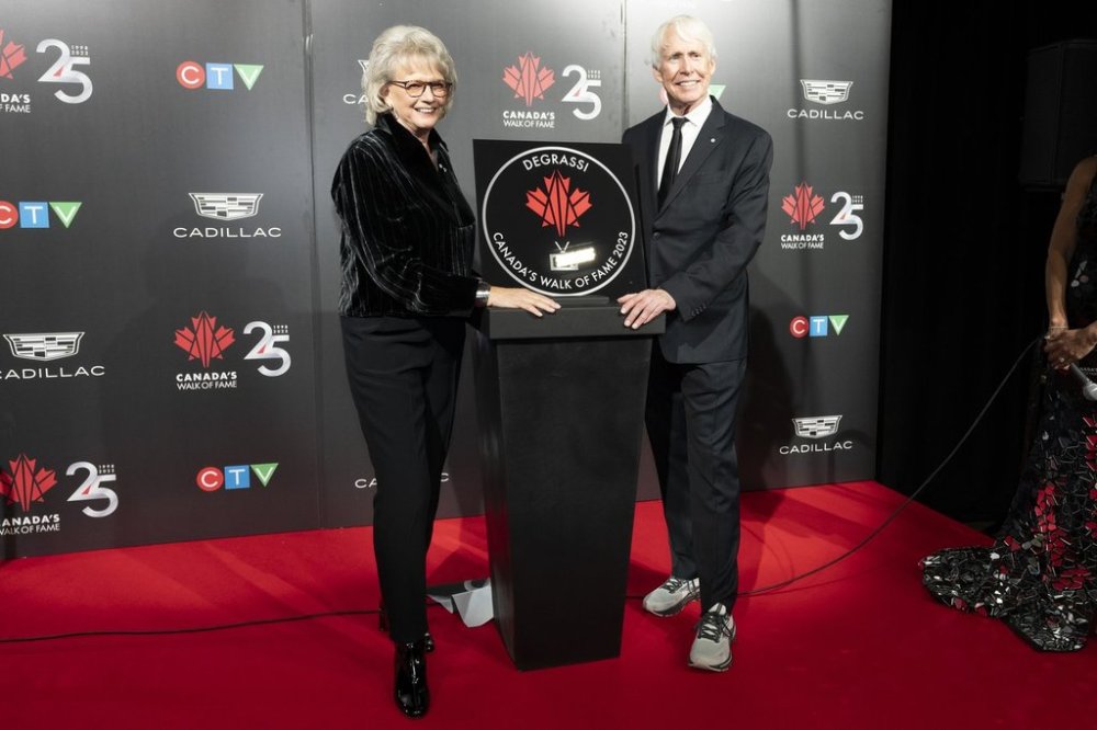 Degrassi creators Linda Schuyler, left, and Stephen Stohn, right, pose with their star at Canada's Walk of Fame's 25th Anniversary gala in Toronto, on Saturday, Dec. 2, 2023. THE CANADIAN PRESS/Arlyn McAdorey