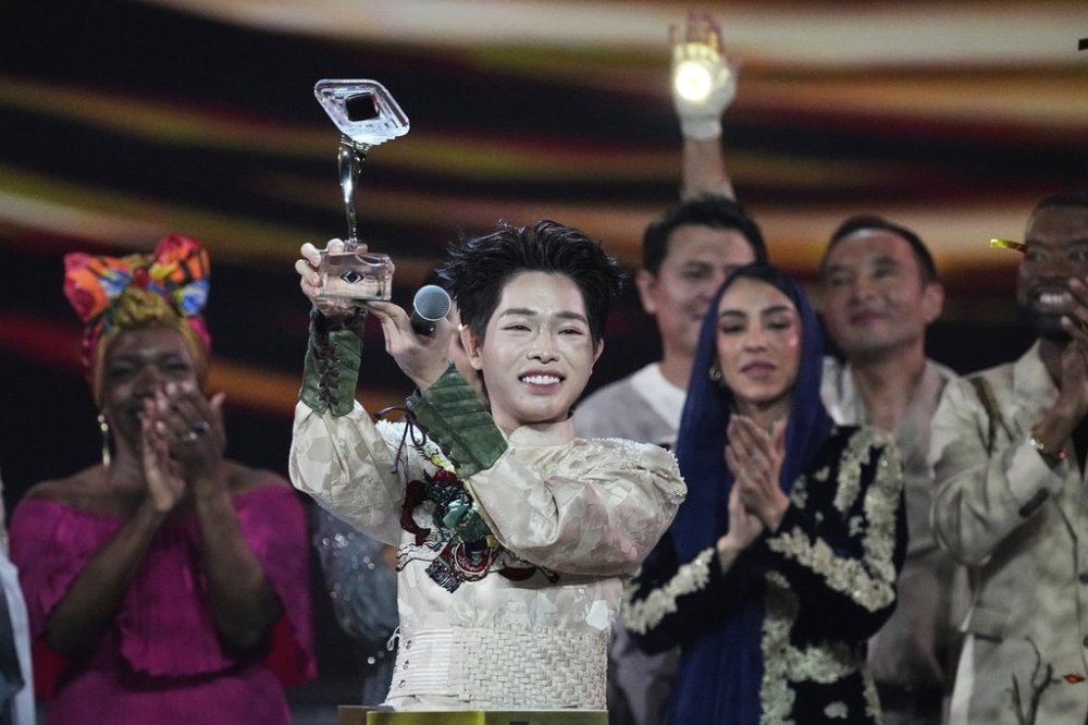 Vietnam's Duc Phuc holds his trophy after winning the International Music Competition