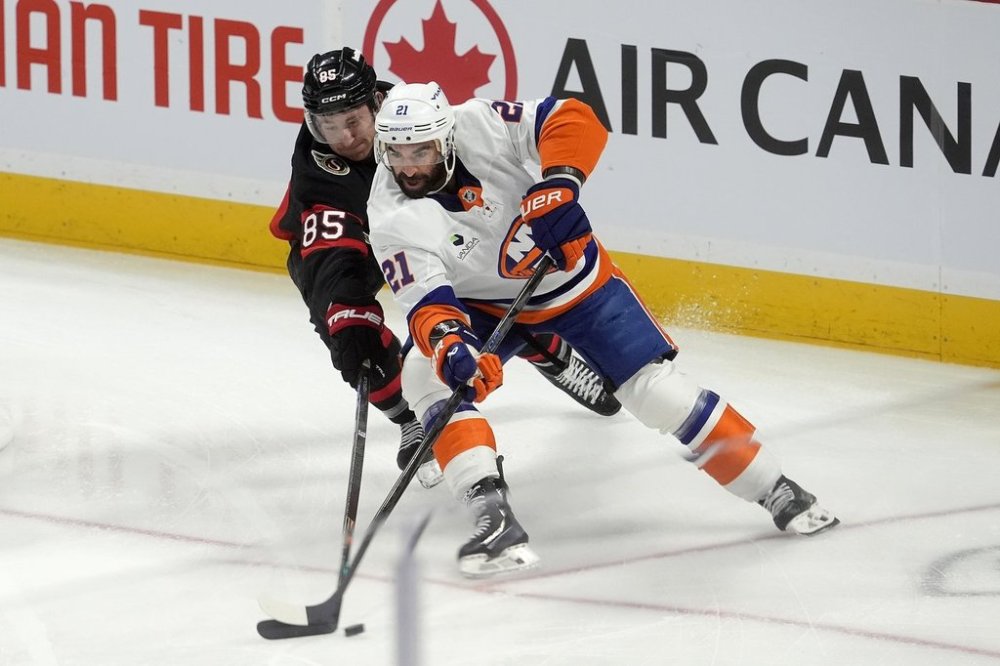 Ottawa Senators defenceman Jake Sanderson (85) pressures New York Islanders centre Kyle Palmieri (21)during first period NHL action in Ottawa, Saturday, Oct. 18, 2025. THE CANADIAN PRESS/Adrian Wyld