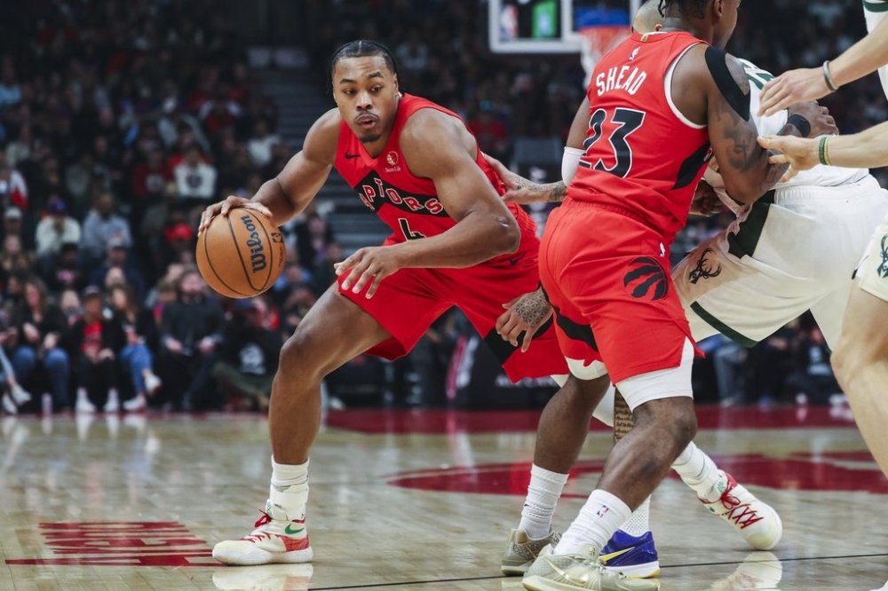 Toronto Raptors' Scottie Barnes (4) moves around a block from teammate Jamal Shead (23) during first half NBA basketball action against the Milwaukee Bucks in Toronto on Friday, Oct. 24, 2025. THE CANADIAN PRESS/Nick Iwanyshyn