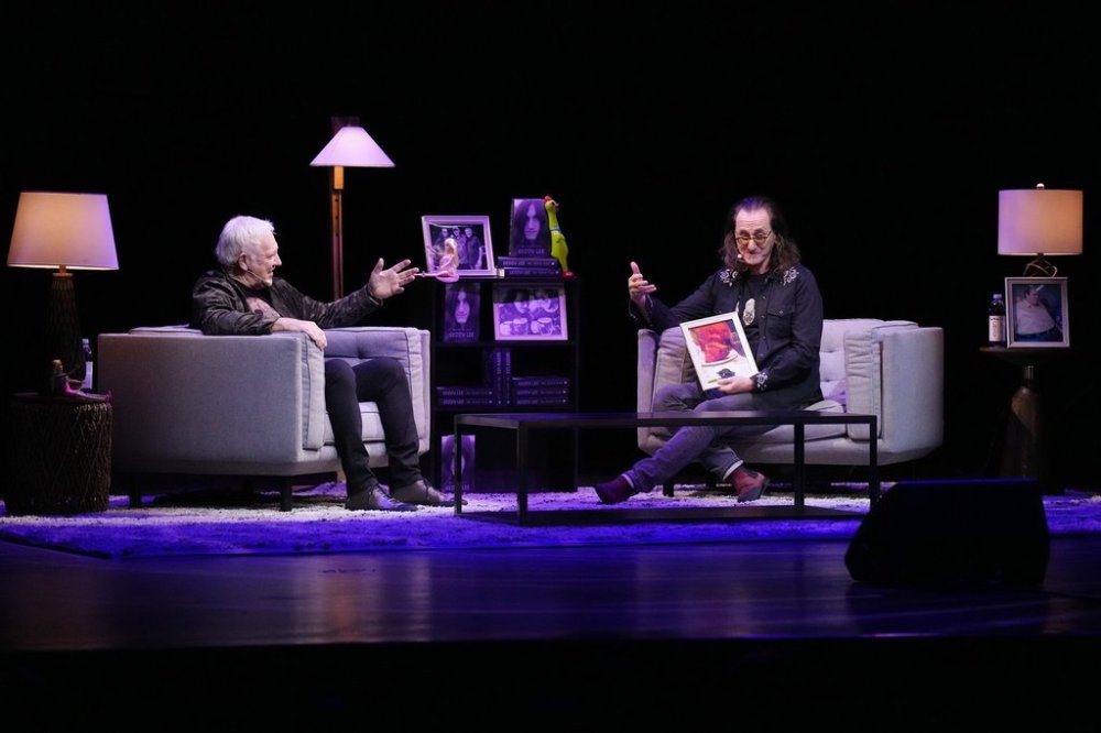 Geddy Lee (right) holds a discussion with fellow Rush band member Alex Lifeson, as he promotes his book