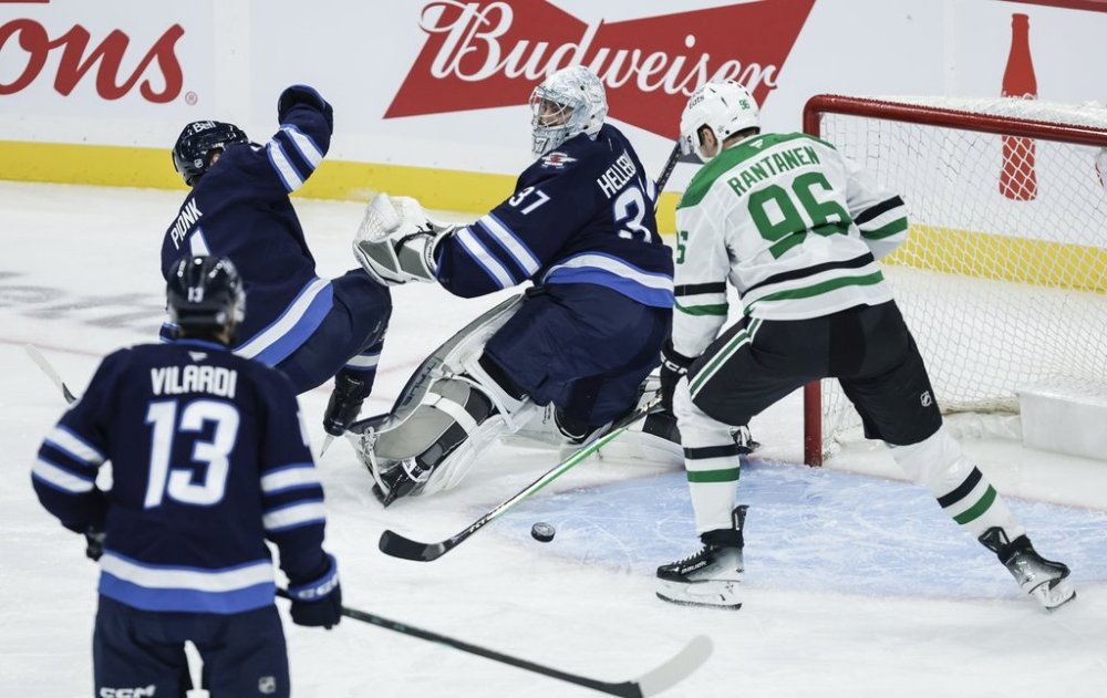 Dallas Stars' Mikko Rantanen (96) scores on Winnipeg Jets goaltender Connor Hellebuyck (37) during first period NHL action in Winnipeg on Thursday, October 9, 2025. THE CANADIAN PRESS/John Woods