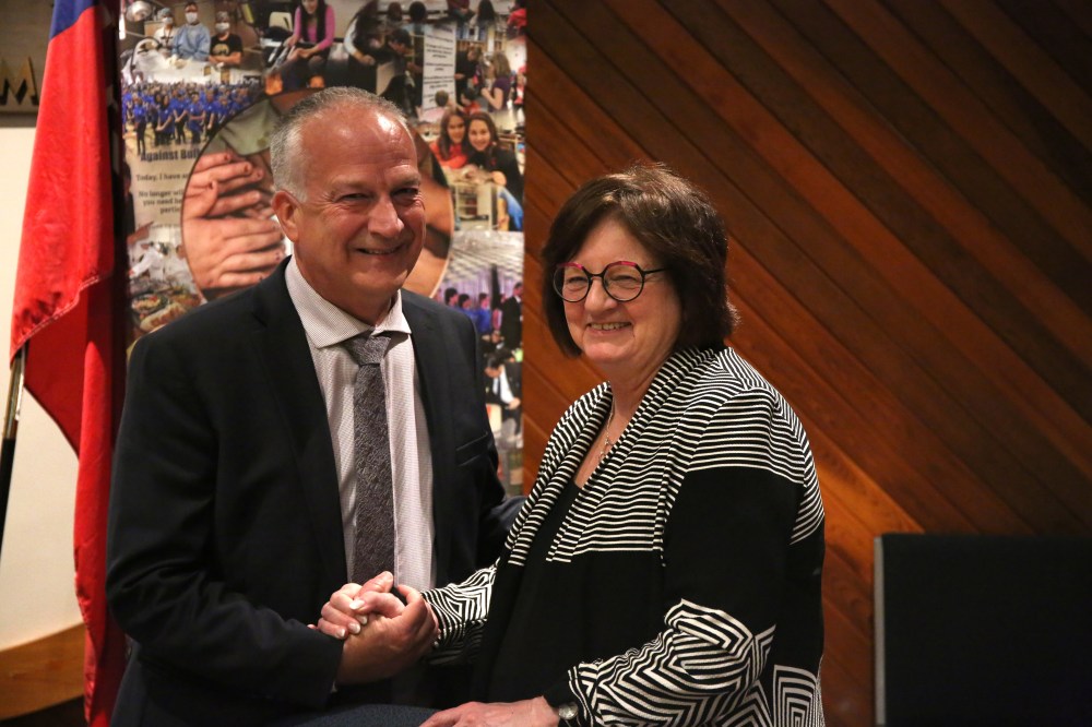Brandon School Division Supt. Mathew Gustafson (left) and the board chair Linda Ross shake hands after the board's general meeting on Tuesday evening. Gustafson has announced his intention to retire in the summer of 2026. (Abiola Odutola/The Brandon Sun)