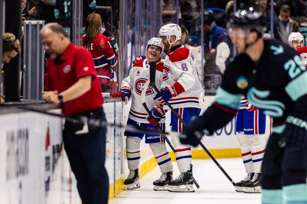 Montreal Canadiens right wing Cole Caufield, left, celebrates with defenseman Mike Matheson after scoring a goal during overtime of an NHL hockey game against the Seattle Kraken, Tuesday, Oct. 28, 2025, in Seattle. (AP Photo/Maddy Grassy)