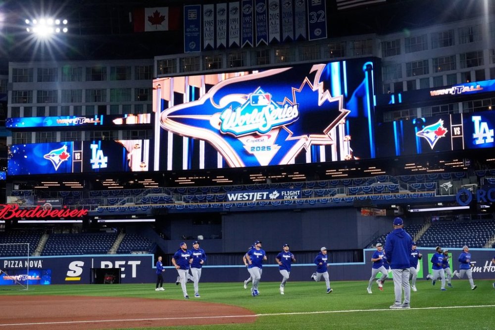 Members of the Los Angeles Dodgers warm up during a team workout on Oct. 23, 2025, in Toronto. The Blue Jays were scheduled to meet the Dodgers in Game 1 of the World Series on Friday. (AP Photo/Brynn Anderson)