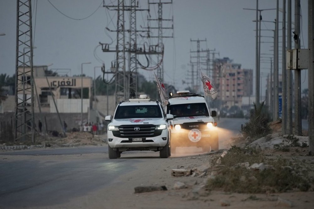 Red Cross vehicles carrying the bodies of two people believed to be deceased hostages handed over by Hamas make their way toward the Kissufim border crossing with Israel, to be transferred to Israeli authorities, in Deir al-Balah, central Gaza Strip, Thursday, Oct. 30, 2025. (AP Photo/Abdel Kareem Hana)