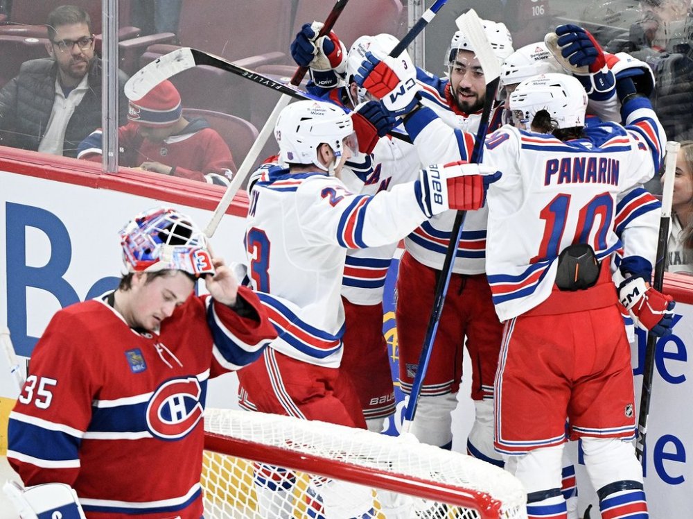 New York Rangers' J.T. Miller, second right, celebrates with teammates after scoriing against Montreal Canadiens goaltender Sam Montembeault (35) during third period NHL hockey action in Montreal, Saturday, Oct. 18, 2025. THE CANADIAN PRESS/Graham Hughes