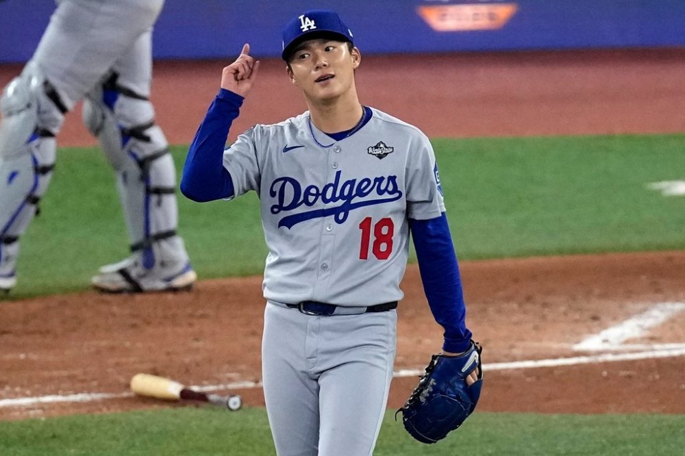 Los Angeles Dodgers' pitcher Yoshinobu Yamamoto celebrates his complete game after Game 2 of baseball's World Series against the Toronto Blue Jays, Saturday, Oct. 25, 2025, in Toronto. (AP Photo/David J. Phillip)