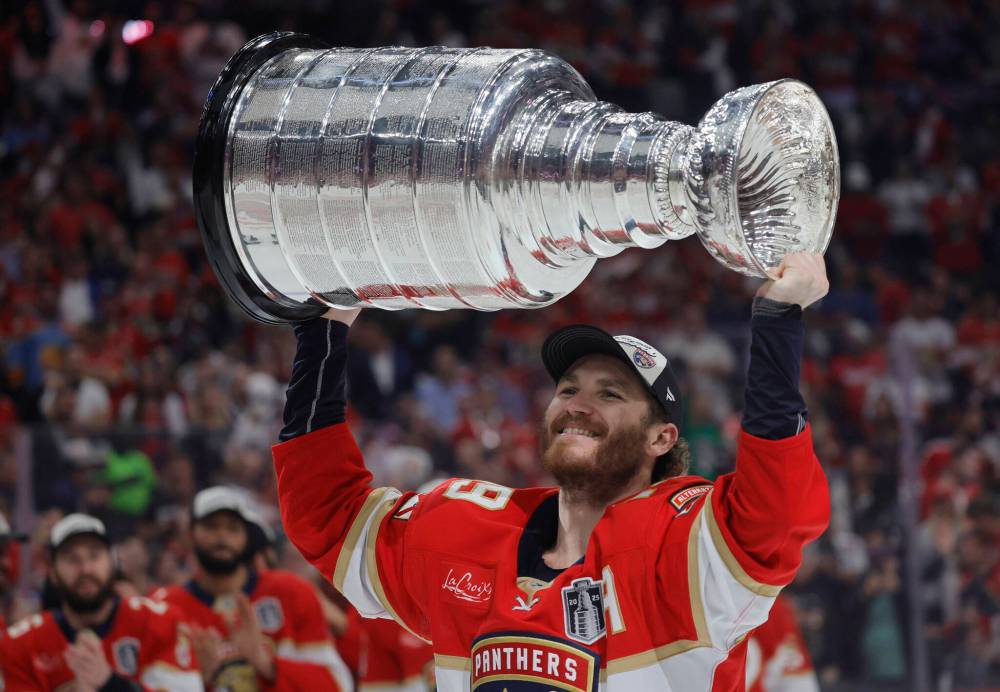 Florida Panthers left winger Matthew Tkachuk (19) skates with the Stanley Cup after a series-clinching win in Game 6 of the Stanley Cup Final on June 17 at Amerant Bank Arena in Sunrise, Florida. Bruce Penton has shared observations on some of the biggest questions heading into the new NHL season; one of them being, can the Panthers three-peat a league title? (Tribune News Service)