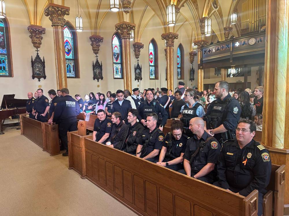 Police, firefighters and other emergency responders are seated in the St. Augustine of Canterbury Church on Thursday morning. A church service was dedicated to public safety workers, with reserved seating in the front rows. (Supplied)
