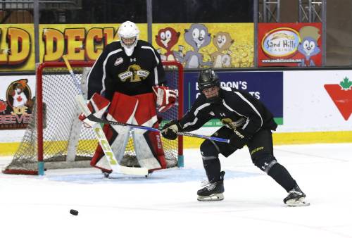 Brandon Wheat Kings callup Cruz Jim chases after the puck in front of goalie Filip Ruzicka during practice at Assiniboine Credit Union Place on Friday afternoon. (Perry Bergson/The Brandon Sun)
                                Oct. 4, 2025