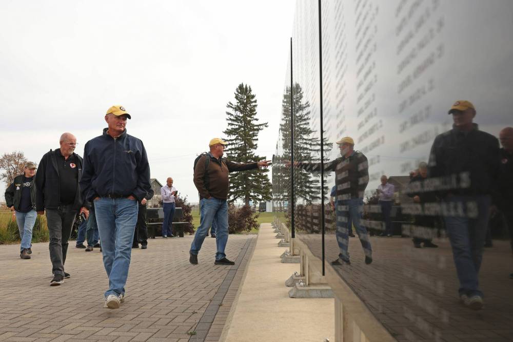 Participants in the conference at the air museum look over the memorial commemorating Canadians who died while serving in the Royal Canadian Air Force in the Second World War. (Tim Smith/The Brandon Sun)