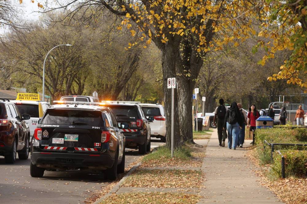 Parents pick up their children at Vincent Massey High School on Friday after the school was placed into a temporary hold and secure. (Tim Smith/The Brandon Sun)