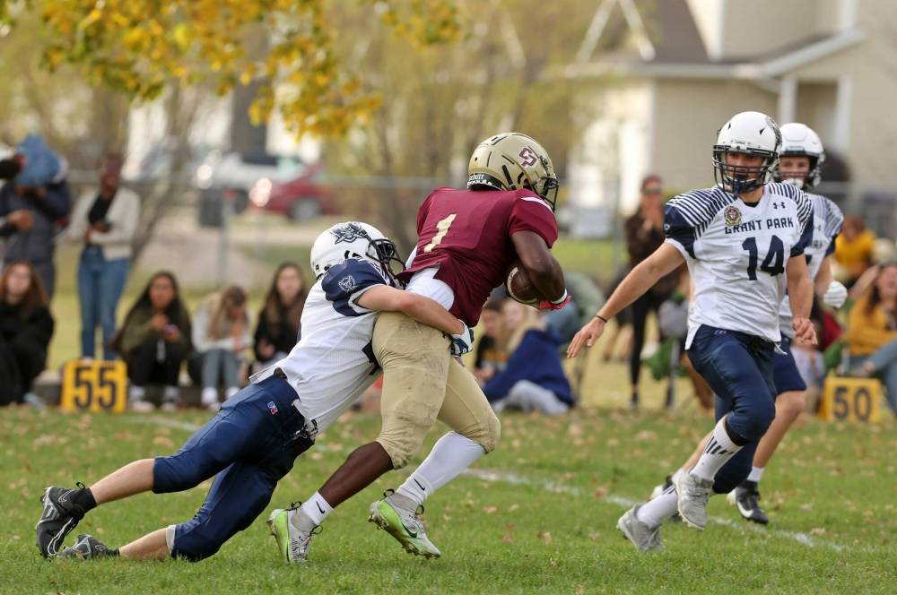 Crocus running back Muqtadir Apena (#1) is tackled while carrying the ball during fourth quarter action against the Grant Park. (Tim Smith/The Brandon Sun)