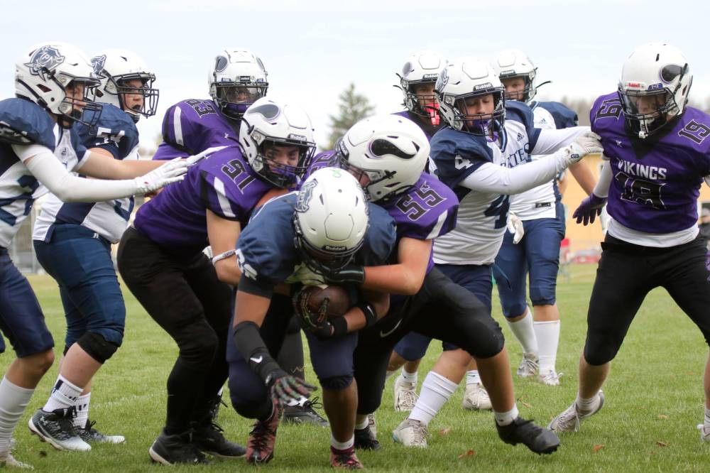 Massey’s Oakley Peters, left, and Lance Burton team up to tackle Grant Parks’ Orlando Brown. (Thomas Friesen/The Brandon Sun)