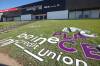 A worker with Off The Wall Signs installs the new lettering for Assiniboine Credit Union Place on the west side of the arena on Tuesday. (Tim Smith/The Brandon Sun)