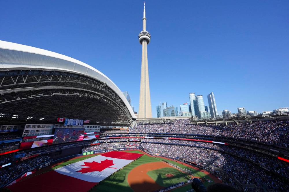 The Canadian flag is displayed on the field during the playing of “O Canada” before the start of an American League Division Series game between the Toronto Blue Jays and the New York Yankees in Toronto last weekend. (The Canadian Press)