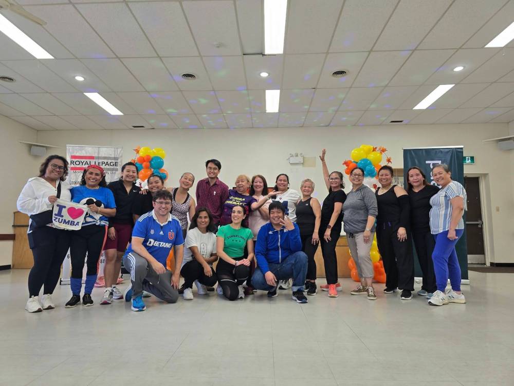 Westman Filipino Community members and guests pose for a group shot during their annual Thanksgiving Celebration Day at the North End Community Centre on Saturday. (Abiola Odutola/The Brandon Sun)