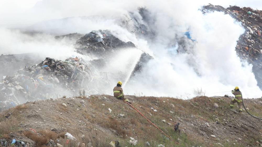 Brandon firefighters spray water into the section of the Eastview Landfill that caught fire on Monday morning. (Abiola Odutola/The Brandon Sun)