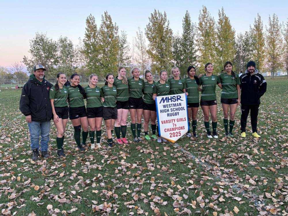 The Dauphin Clippers rugby team with the championship banner. (Dauphin Herald)