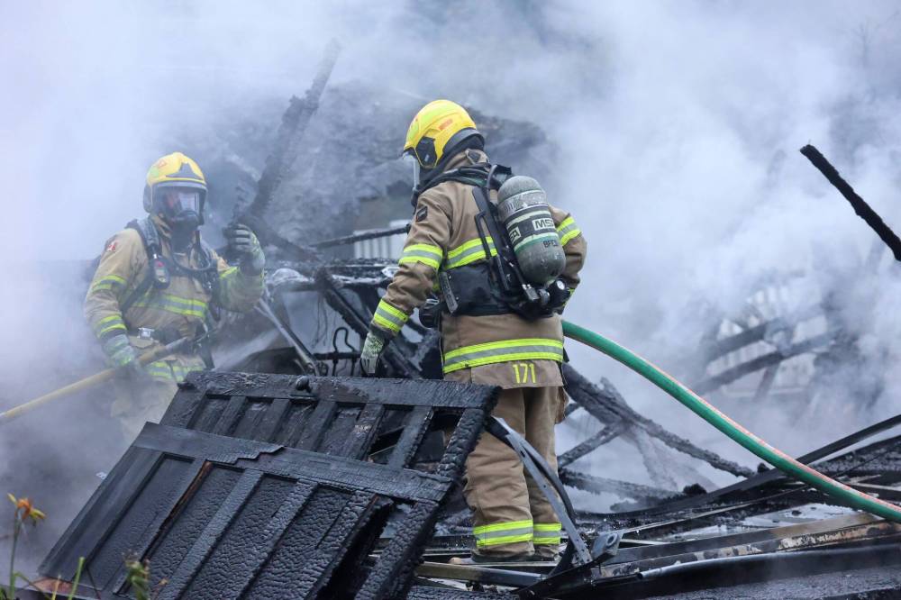 Brandon firefighters work to quelch remaining hot spots on a garage that burned down on Wednesday afternoon on the 400 block of 16th Street. (Matt Goerzen/The Brandon Sun)
