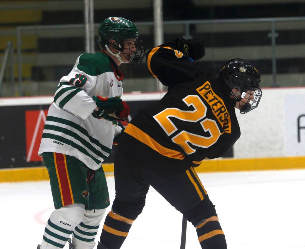 Wheat Kings U18 defenceman Nolan Peterson (22) battles in front of the Brandon net alongside Winnipeg Wild forward Dylan Prettie (19) during Manitoba U18 AAA Hockey League action at the hockey for all centre last Saturday. (Massimo De Luca-Taronno/The Brandon Sun)
