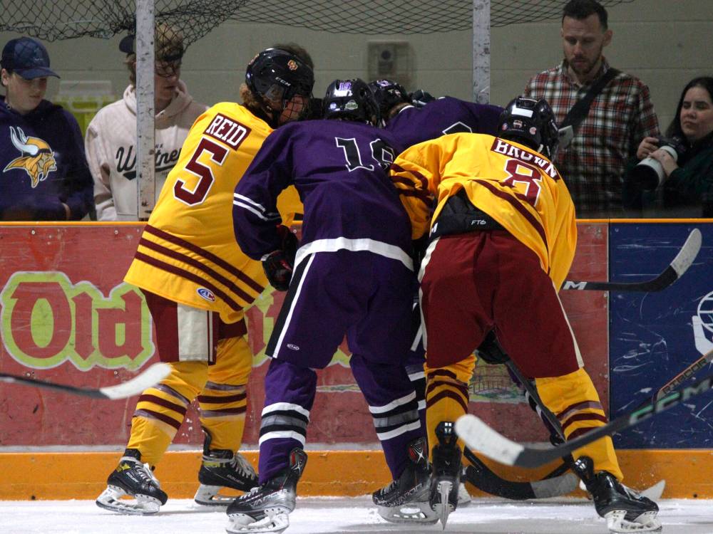 Players of the Crocus Plainsmen and Vincent Massey Vikings battle for the puck along the boards during Westman High School Hockey League action. (Massimo De Luca-Taronno/The Brandon Sun)