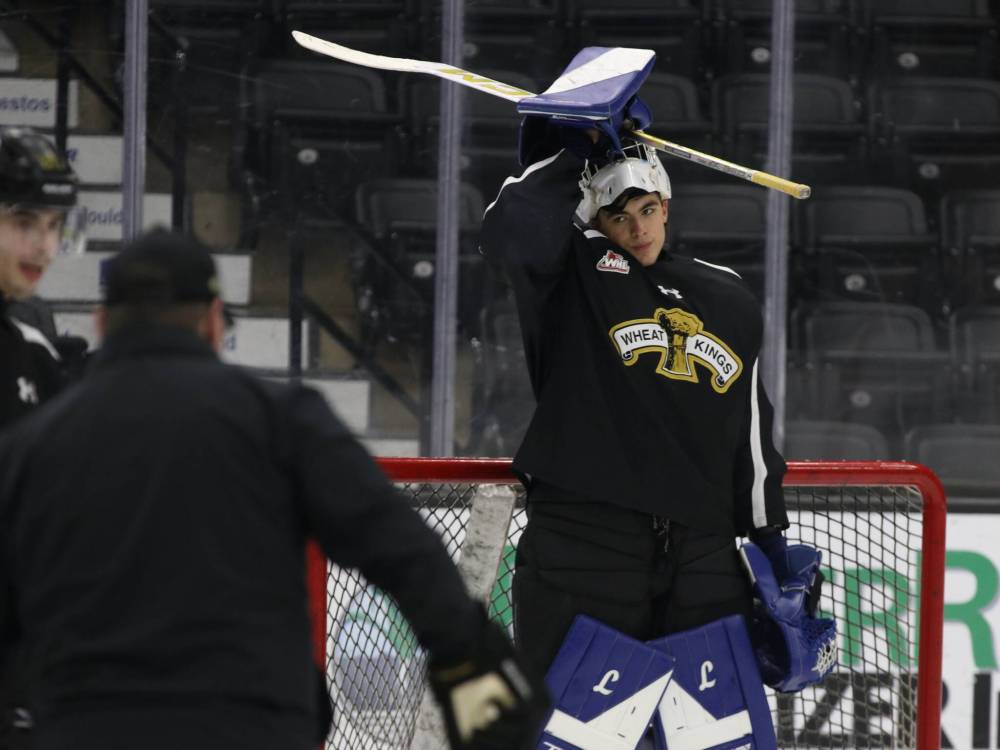 Brandon Wheat Kings goaltender Filip Ruzicka pulls his mask down at practice on Thursday at Assiniboine Credit Union Place. The Czech goaltender is finding his way in Brandon after a transfer issue put him a month behind his teammates. (Perry Bergson/The Brandon Sun)