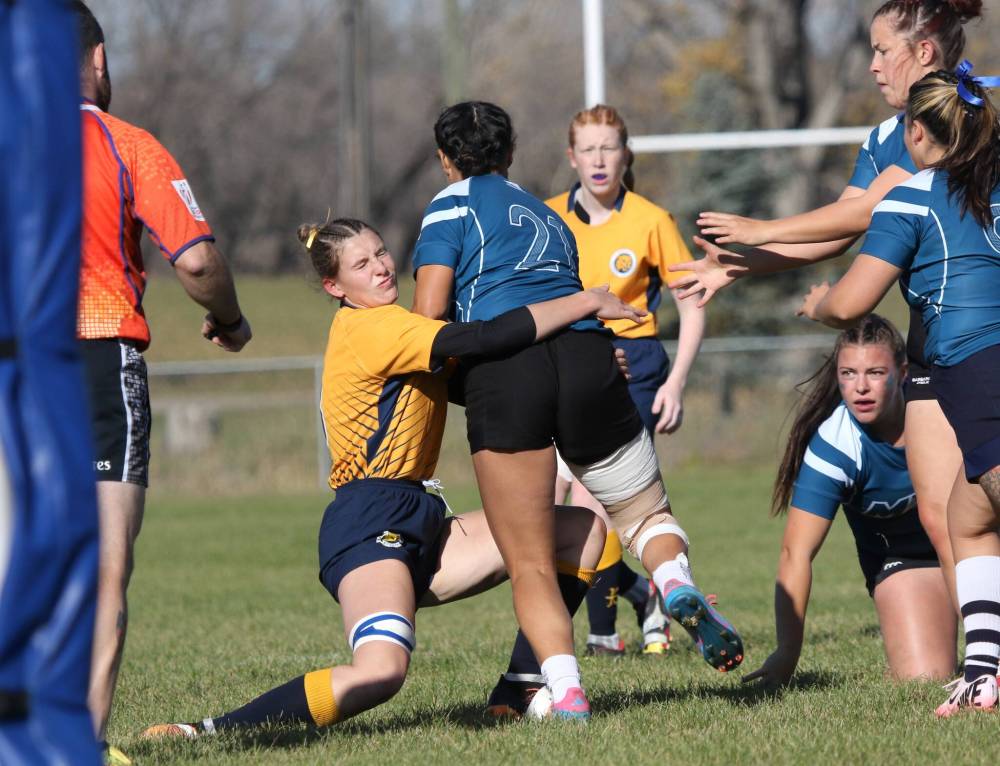 Brandon University's Brooke Miner tackles a Mount Royal ball carrier during their Prairie University Women's Rugby Conference semifinal at John Reilly Field on Friday. (Thomas Friesen/The Brandon Sun)