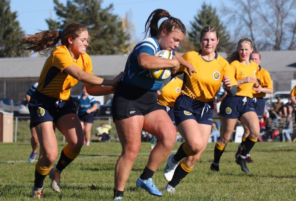 Brandon University’s Raegan Ricard tackles a Mount Royal ball carrier during their Prairie University Women’s Rugby Conference semifinal at John Reilly Field on Friday. (Thomas Friesen/The Brandon Sun)