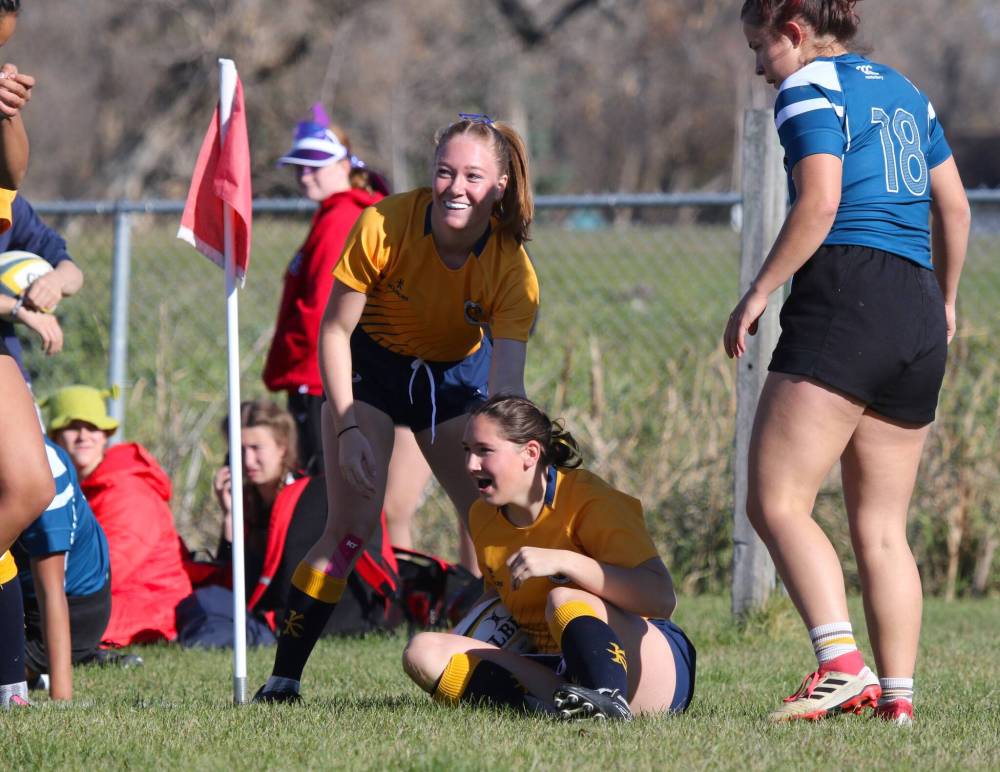 Calle Peters scores a try for Brandon University as Shaina Beswitherick pats her on the back during the first half of their Prairie University Women’s Rugby Conference semifinal against Mount Royal University at John Reilly Field on Friday. (Thomas Friesen/The Brandon Sun)