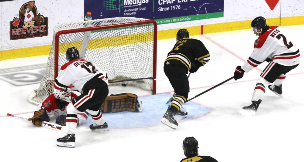 Brandon Wheat Kings forward Chase Surkan (11) backhands a shot behind Moose Jaw Warriors goalie Matthew Hutchinson (54) and defenceman William Degagne (12) to score the first of his three goals in Western Hockey League action at Assiniboine Credit Union Place on Sunday. (Perry Bergson/The Brandon Sun)
                                Oct. 26, 2025