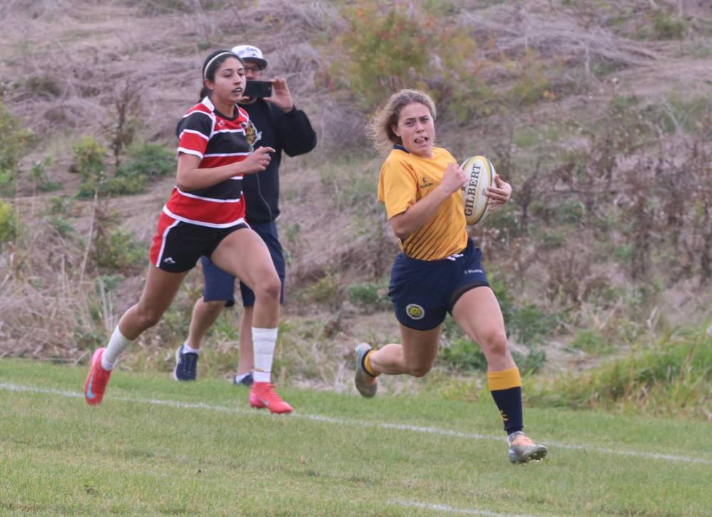 Raegan Ricard of the Brandon University Bobcats rumbles past a Southern Alberta Institute of Technology (SAIT) Trojans defender for a late try to pull her team within two points with four minutes left in the Prairie University Women’s Rugby Conference final at John Reilly Field on Sunday.
