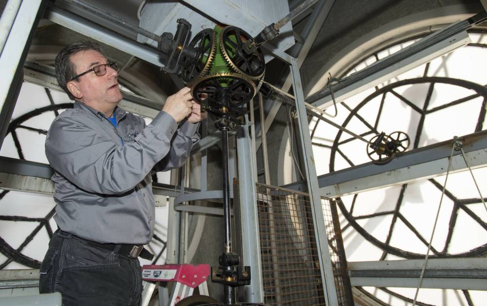 John Scott of Scotiabell prepares the tower clock for the Daylight Savings time change at Fire Station No. 315 in Toronto in March 2019. (The Canadian Press files)