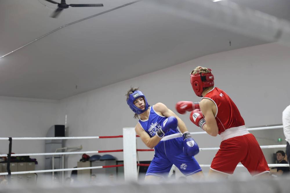 Brandon Fitness Combat Academy boxer Jesse Kreutzer dodges a punch from Simon Federkevik of Pan Am Boxing Club (Winnipeg) during the annual Fall Brawl Boxing event in the 70-kilogram category on Saturday evening. Kreutzer won the bout. (Photos by Abiola Odutola/The Brandon Sun)